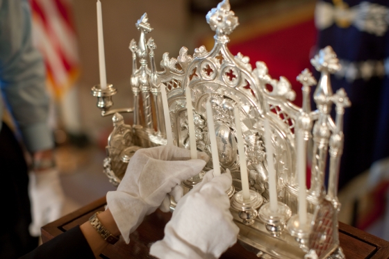 Donna Hayashi Smith handles the 1873 silver Hanukkah menorah  on loan from the Jewish Museum in Prague, Czech Republic,